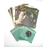 A small collection of 12" and 7" vinyl records comprising of The Doors, The Beatles, Paul and