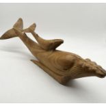 A large carved wooden whale - length 79cm