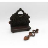 A continental carved wooden watch stand along with a loving spoon