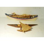 A model boat along with a tribal wooden model of an outrigger (A/F)