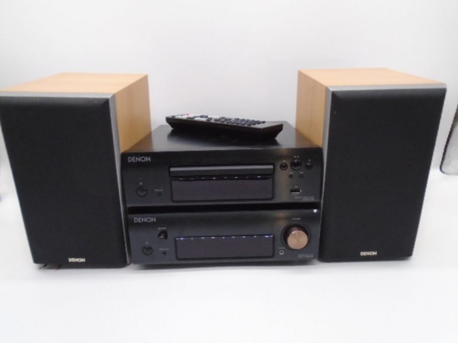 A Denon compact disc player, along with Denon stereo receiver and pair of Denon speakers (all