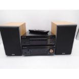 A Denon compact disc player, along with Denon stereo receiver and pair of Denon speakers (all