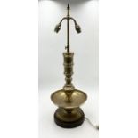 An Eastern brass table lamp on turned wooden base