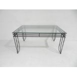 A modern wrought iron framed garden table with glass top - length153cm, depth 92cm, height 77cm