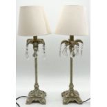 A pair of modern crystal drop lamps with shades