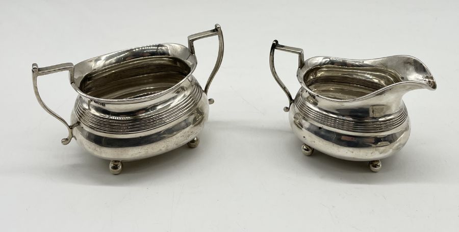 A hallmarked silver Georgian tea pot, London 1807 with a matched sugar and cream jug - Sheffield - Image 4 of 5
