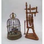 A miniature brass bird cage with a spinning wheel model (height 24cm).