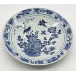 A large 19th century blue and white Chinese charger with floral and bird motif to the front and
