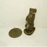 A reconstituted stone otter garden ornament along with a brass sun dial