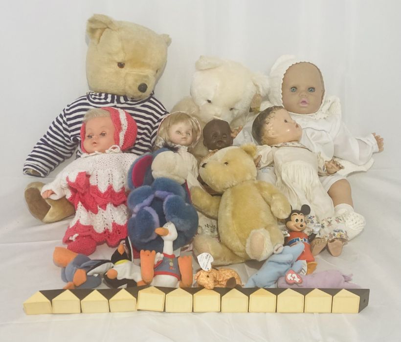 A collection of vintage dolls and soft toys including Winnie The Pooh, limited edition Gund teddy