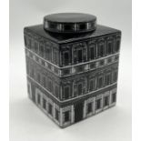 A square lidded jar decorated with architectural detail in the style of Piero Fornasetti - height