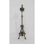 A converted oil lamp on wrought iron stand