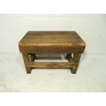 A small industrial wooden stool - from Axminster Carpets - length 53cm, depth 33cm, height 34cm