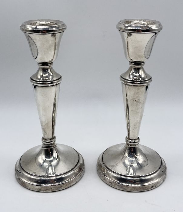 A pair of hallmarked silver candlesticks, height 14.75cm