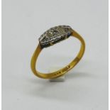 An Art Deco 18ct gold and platinum diamond three stone ring