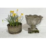 A reconstituted stone urn on plinth along with a planter with basket decoration