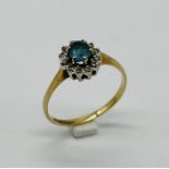 A 9ct gold topaz and diamond cluster ring