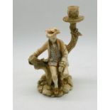 A Royal Worcester candlestick figure of a seated gentleman