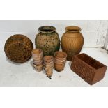 A collection of terracotta including garden ornament in the form a golf ball, urns, pots, small