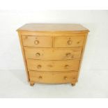 A Victorian pine bow-fronted chest of five drawers, raised on turned feet - length 104cm, depth