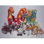 A collection of various toys including a selection of various plastic farm animals, two toy