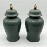 A pair of modern crackle glazed ginger jars with Foo dog finials