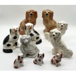 A collection of Staffordshire style dogs including three matching pairs