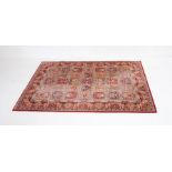 A Belgian red ground wool rug by 'Lano Carpets' (Nain) with traditional Eastern design - 237cm x