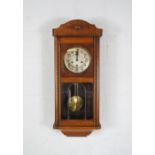 A mahogany chiming wall clock