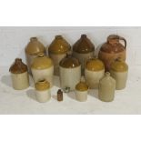 A large collection of stoneware flagons and jars, along with a terracotta jug - many A/F