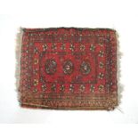 A small Eastern red ground rug - 61cm x 50cm