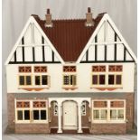 A large vintage dolls house, along with a collection of dolls house furniture (some A/F)