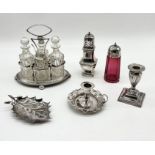 A collection of mainly silver plated items including a cranberry glass sugar castor, a condiment set