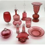 A collection of cranberry glass including large vase with etched detail, decanter, two scent