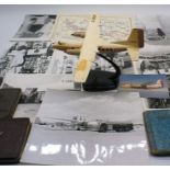 A model plane (propeller blades missing) and a collection of photographs documenting the 14000