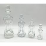 A collection of four Holmegaard Kluk Kluk decanters in decreasing size, largest measures 32cm and