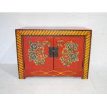 An Oriental lacquered cabinet with hand painted floral decoration - length 82cm, depth 40cm,