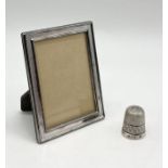 A small 925 silver photo frame along with a silver thimble