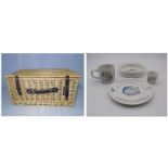 A wicker basket with a Wedgwood Beatrix Potter Peter Rabbit set consisting of cup, bowl, side
