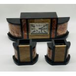 An Art Deco marble clock with garnitures