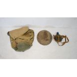 A British military helmet along with a canvas rucksack and a water bottle