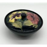A Moorcroft Hibiscus lidded pot with stamp and label to base