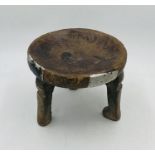 An African tribal three legged stool with dished seat - rudimental repair