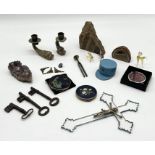 A collection of miscellaneous items including geodes, compacts, antique keys, brass candle holders