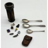 A collection of items including three silver spoons, WW2 bomb tail, collection of antique glass