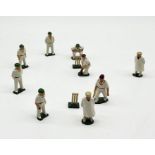 A collection of lead cricket figures including two umpires, bowler, two batsmen, three fielders, two