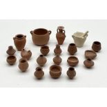 A collection of miniature clay pots, bowls etc.