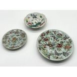 Three Chinese Celadon and Famille Rose plates including footed dish with bird motif and character