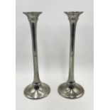 A pair of large metal candlesticks, height 48cm