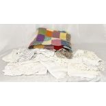 A collection of antique and other lace and linen along with a vintage hand knitted patchwork